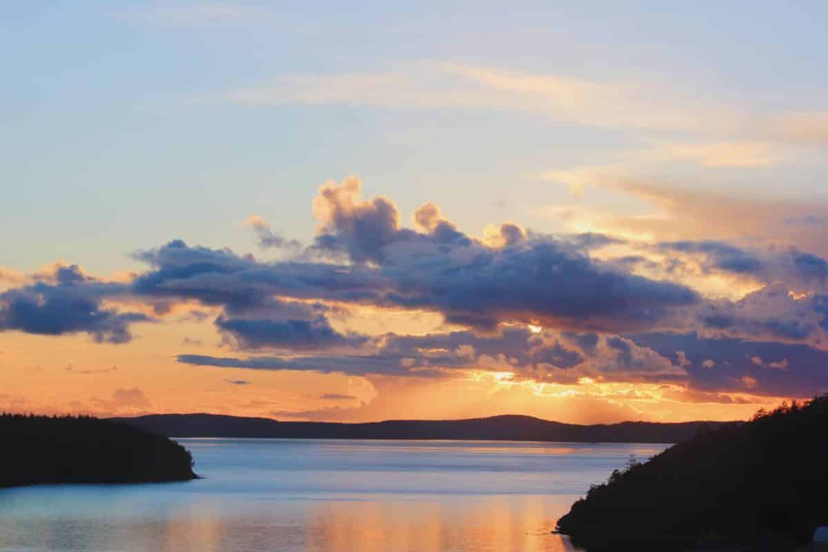 Sunset over mountains and water