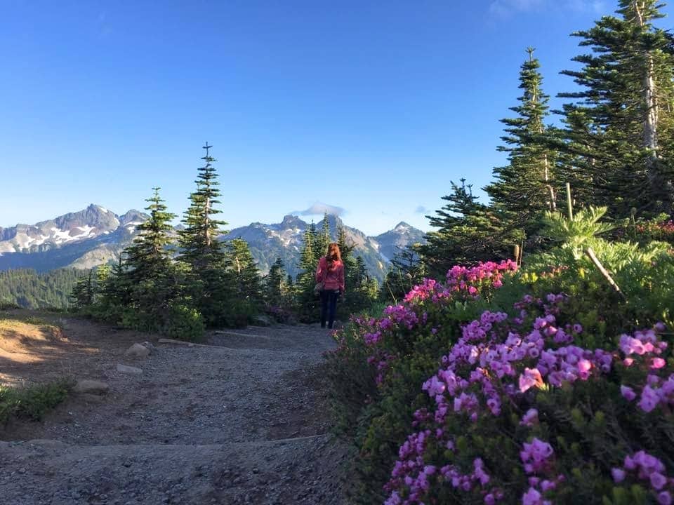 Paradise Trail Woman walking by wild flowers