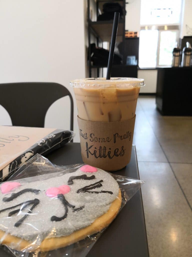 Kitty Cantina Spokane Iced coffee and cat cookie on table