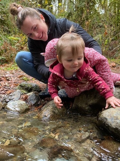 toddler playing in creek