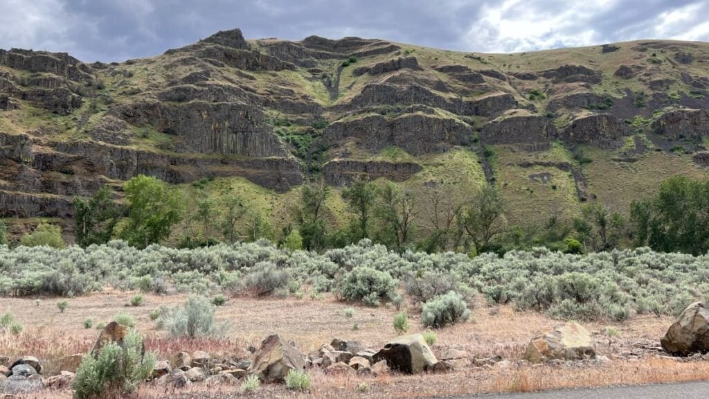 Layered basalt cliffs and columnar rock formations along the Yakima River Canyon