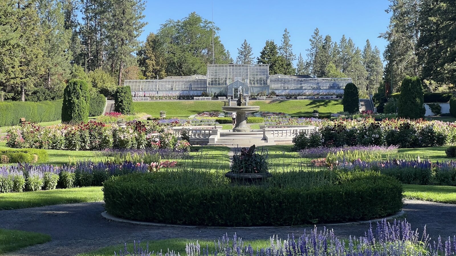 Duncan Garden fountain and lavender beds with the Gaiser Conservatory behind at Manito Park in Spokane