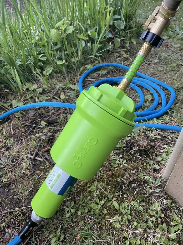 RV water filter and hose connected to a campground spigot