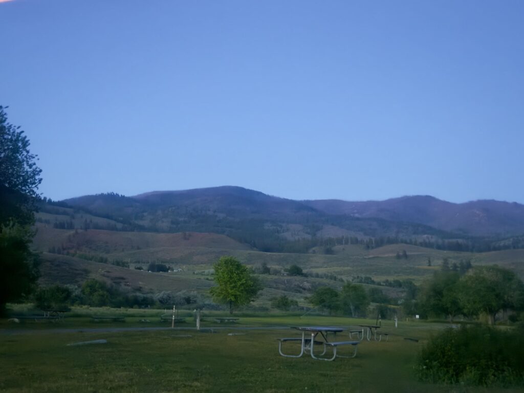 The picnic area at Pearrygin Lake State Park at dusk, with the Methow hills fading into blue