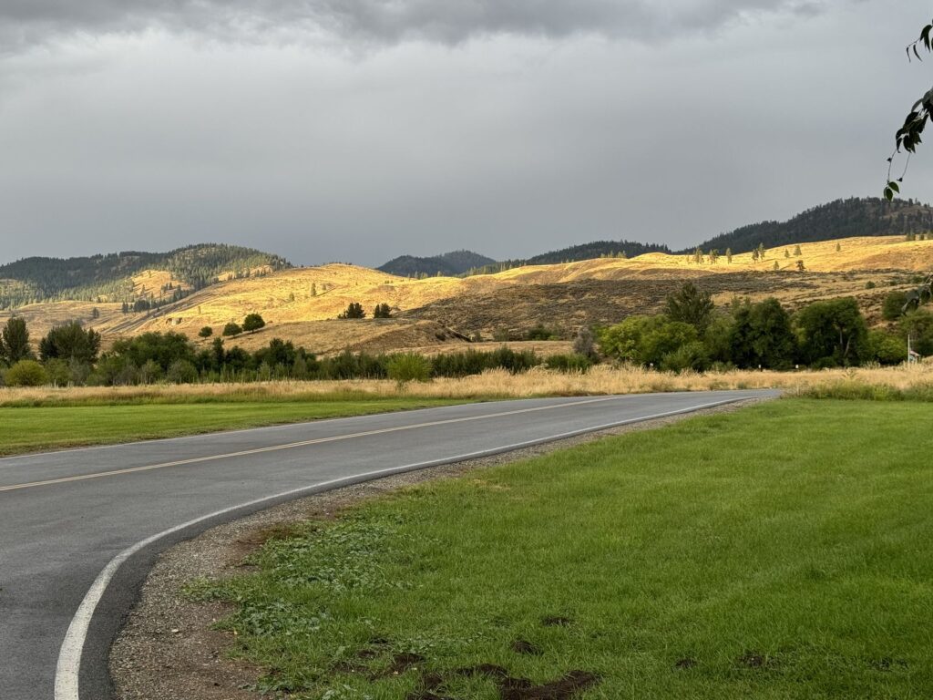 Late sun on the dry golden shrub steppe hills above Pearrygin Lake State Park under a storm sky