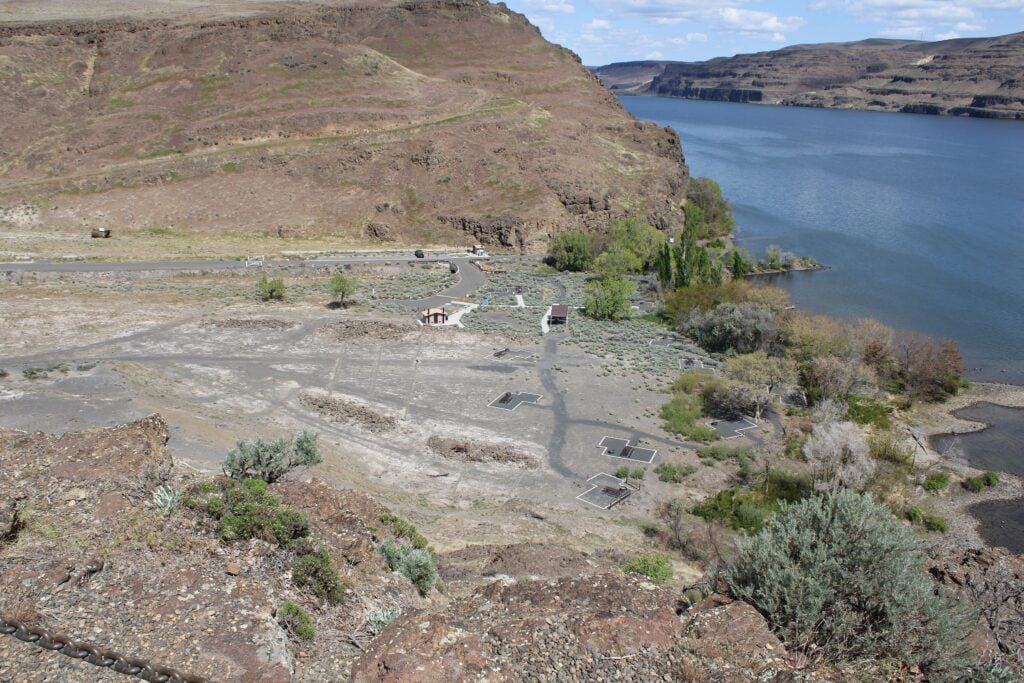 Campsites at Rocky Coulee Recreation Area on the Columbia River in eastern Washington, with dry basalt coulee walls rising above the shoreline