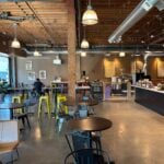 Bright interior of Boon Boona Coffee in Renton with yellow stools, tables and a long counter