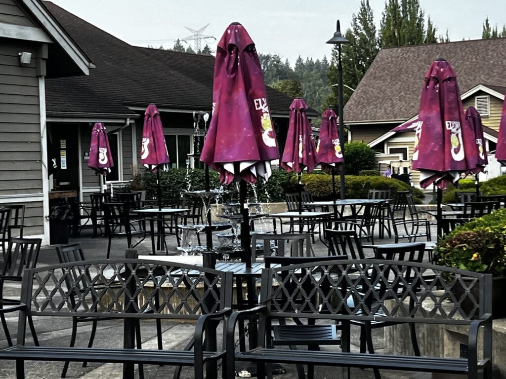 The patio at River Rock Grill at Maplewood Golf Course with red umbrellas