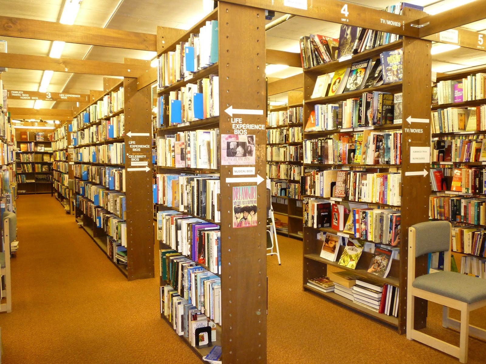Wooden aisles of numbered shelves inside 2nd Look Books