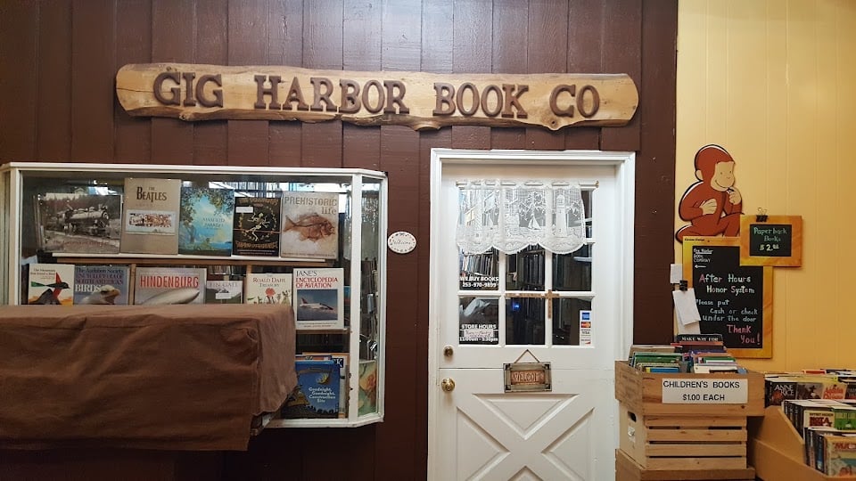 The carved Gig Harbor Book Co sign above a doorway inside the shop