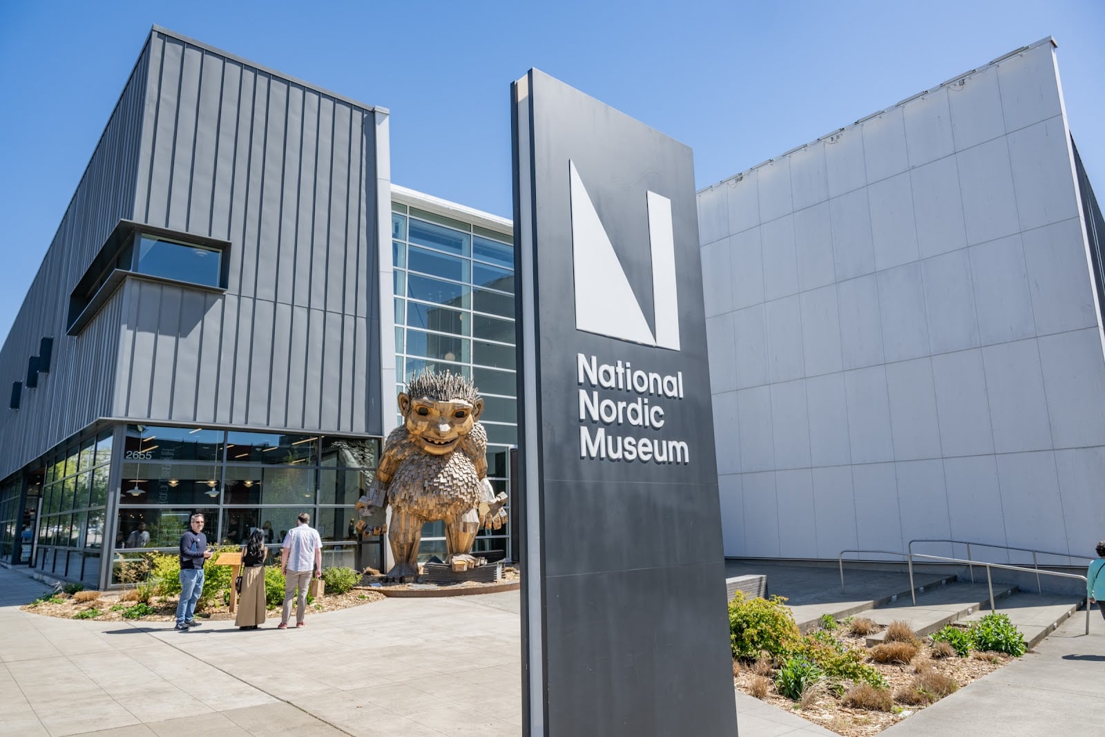 Entrance of the National Nordic Museum in Ballard with its tall N sign and a large troll sculpture