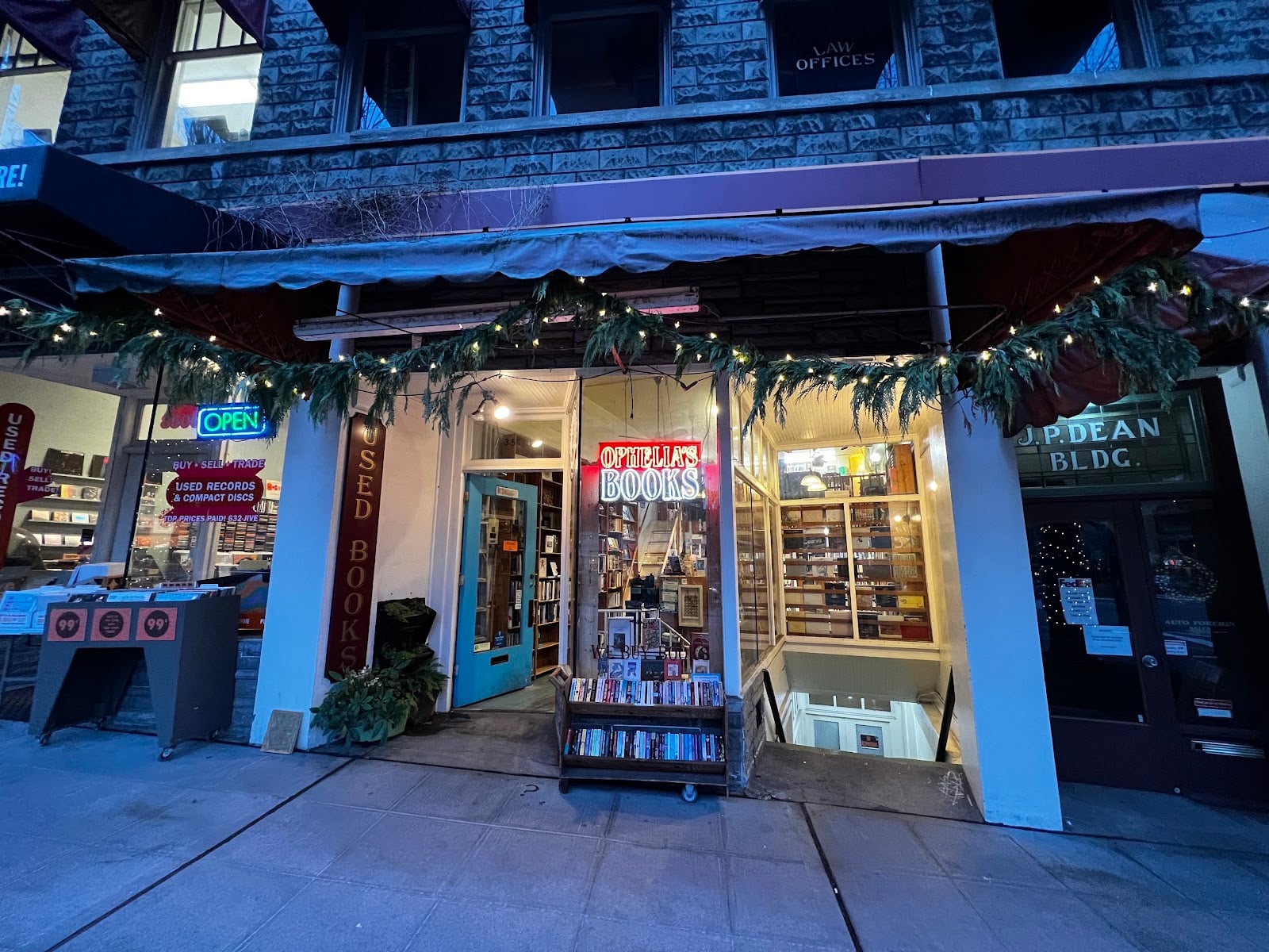 The Fremont Avenue storefront of Ophelia's Books with books on a cart by the door