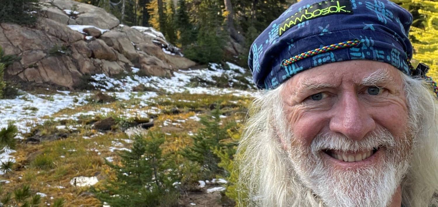 Scott Griffith of Washington State Parks on a snowy trail among golden larches