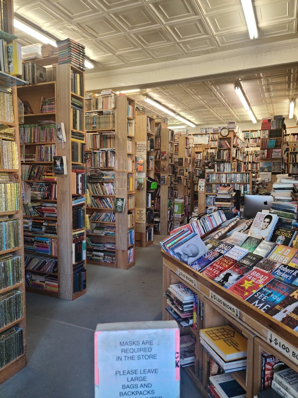 Crowded shelves and display tables inside Tacoma Book Center